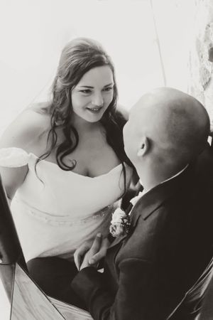 A romantic black and white portrait captures an intimate moment between newlyweds.