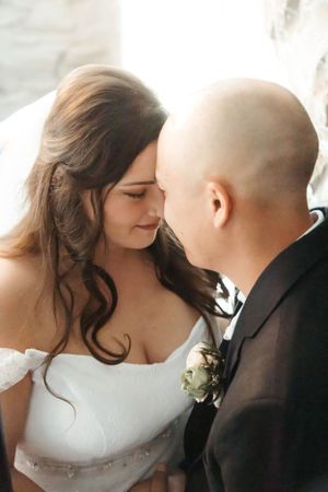 A tender moment captured between newlyweds in soft natural lighting.