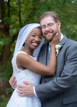 Portrait of a joyful newlywed couple embracing.
