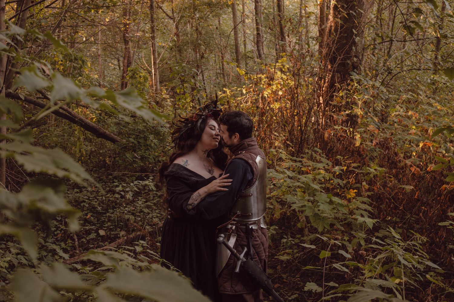 A witch and a knight cozy up for their engagement photos in the middle of Stanley Park.