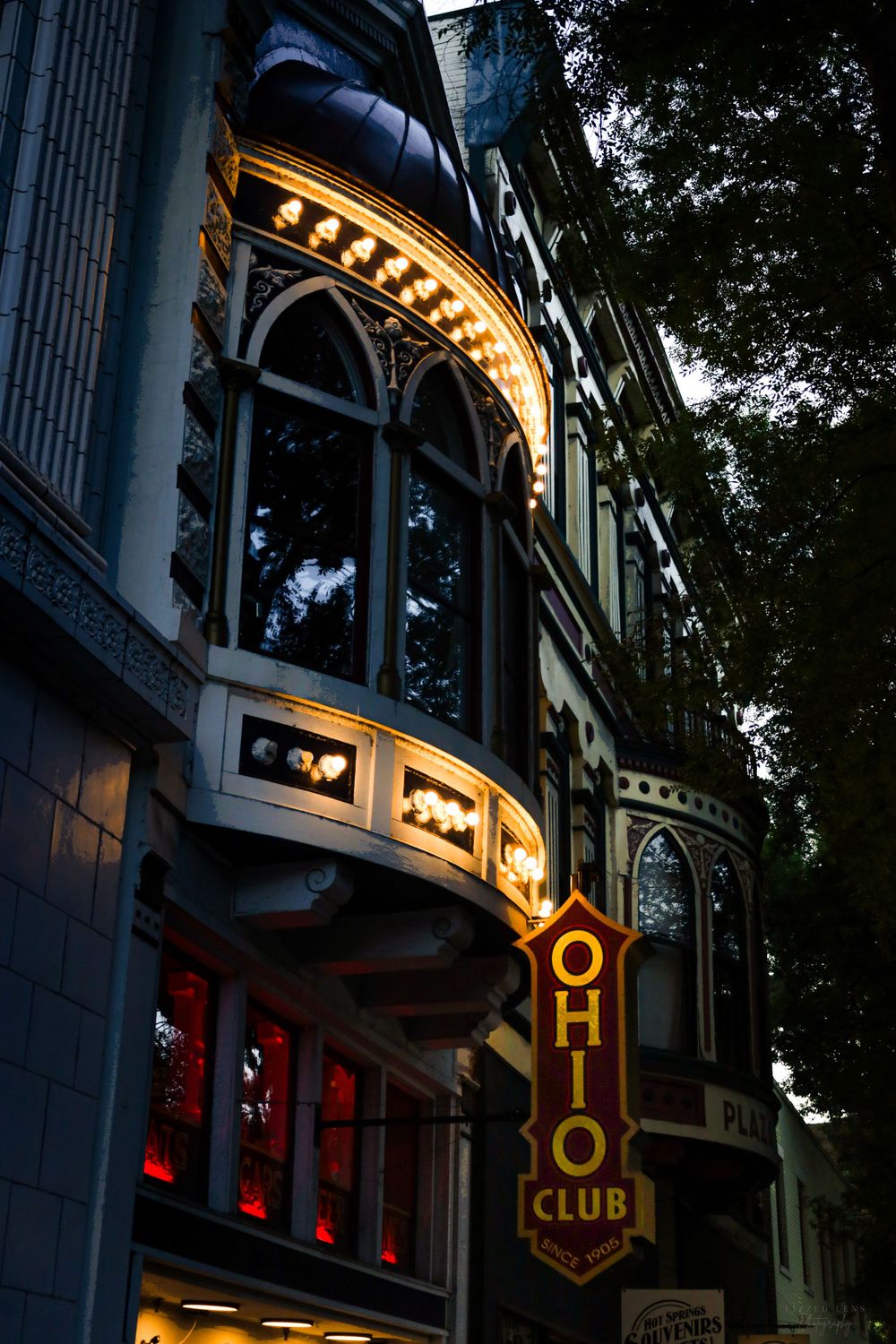 Ornate Ohio Club building facade illuminated at dusk with glowing marquee sign and decorative Gothic-style windows.