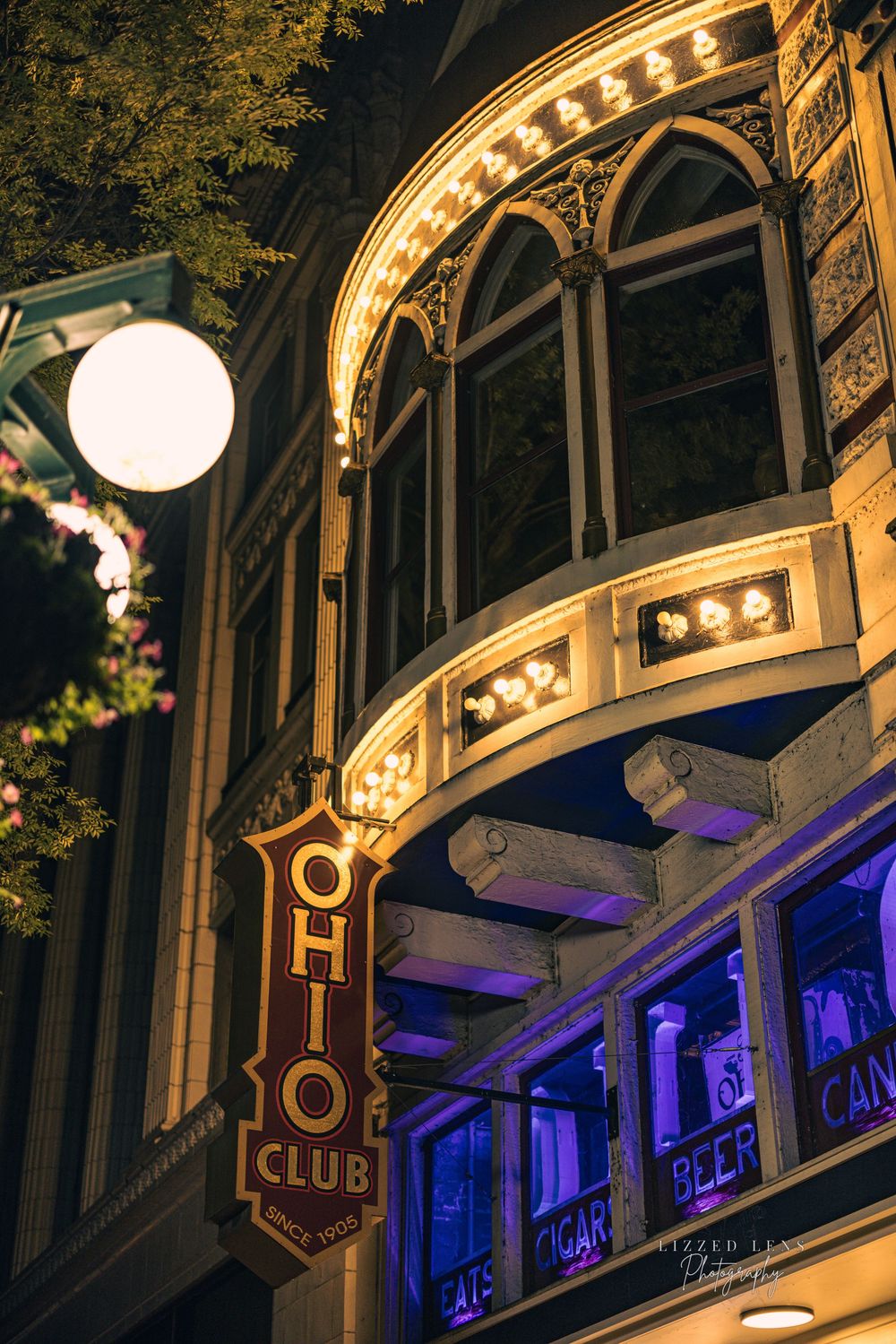 Ohio Club vintage neon sign with ornate architecture and purple lights at night.