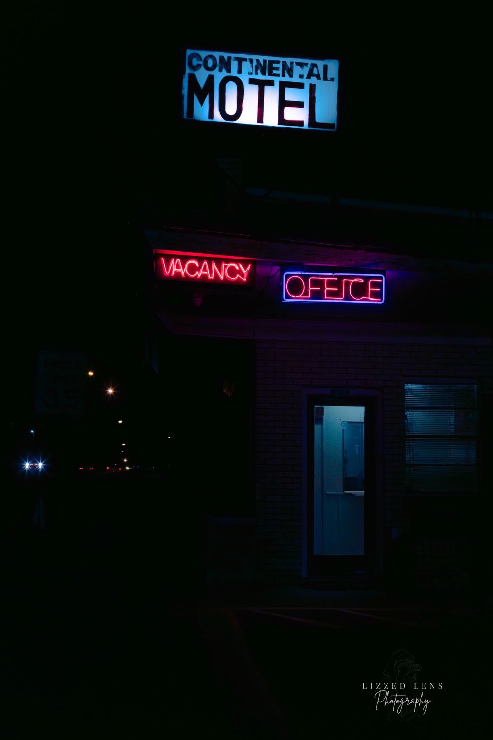 Continental Motel with glowing red neon vacancy and office signs in the dark night.
