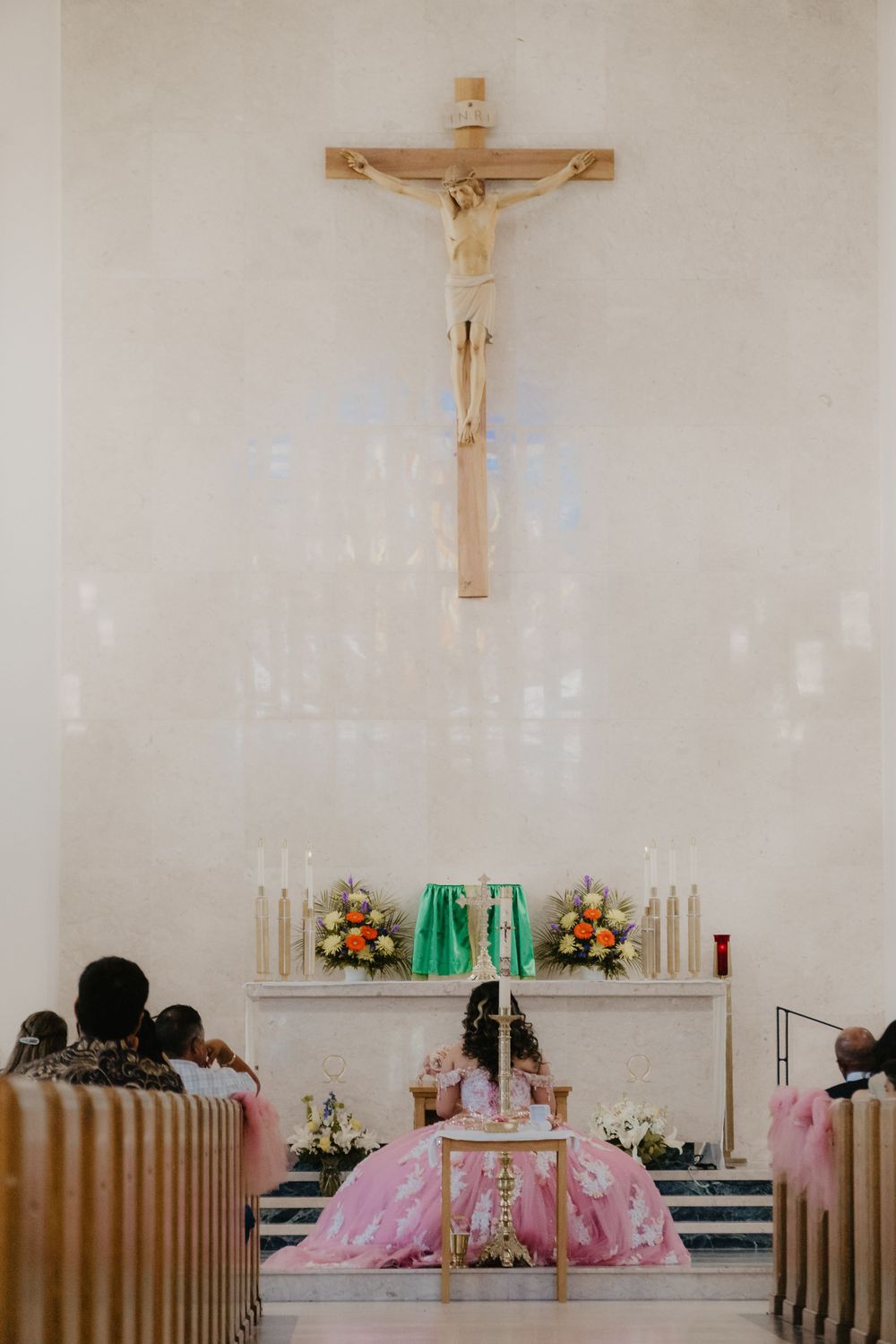 Quinceañera kneeling during Catholic quinceañera mass, Knoxville