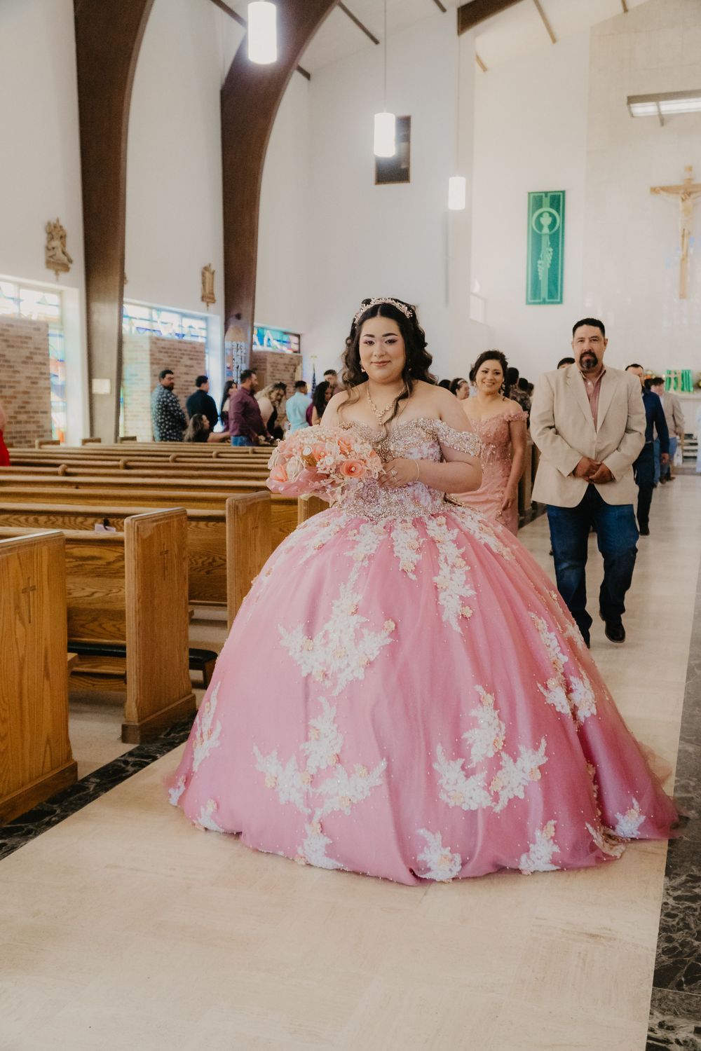 Quinceañera walking down the aisle for Misa de acción de gracias