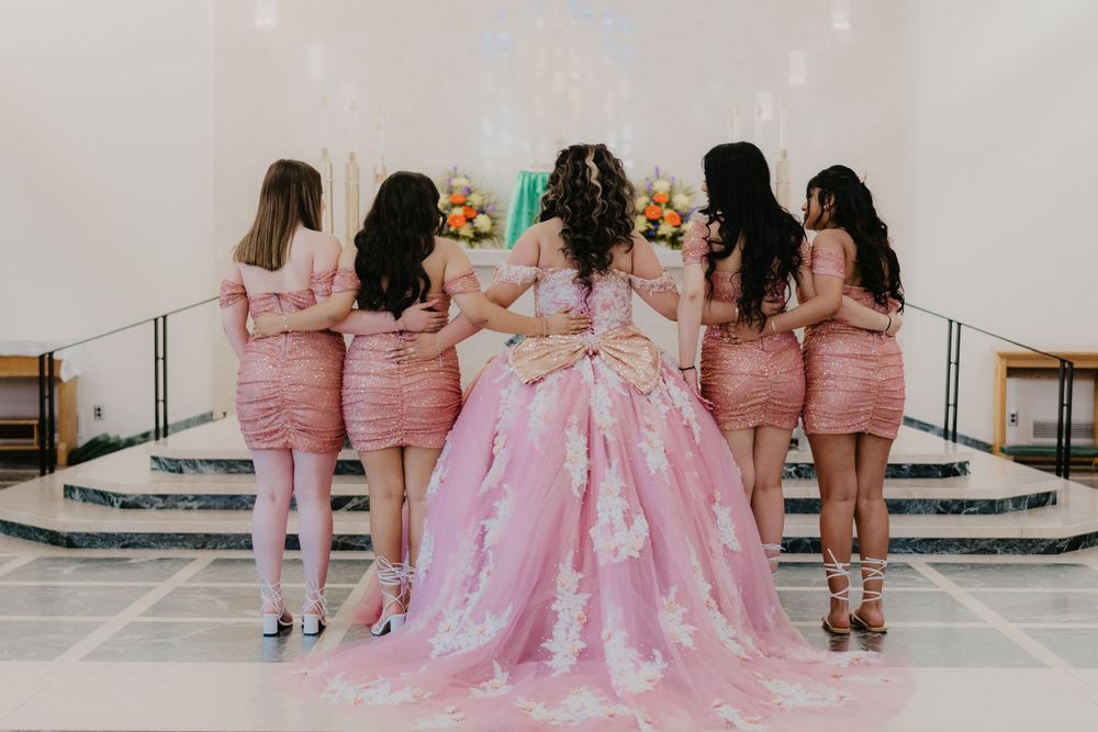quinceañera with damas taking pictures during mass, oak ridge