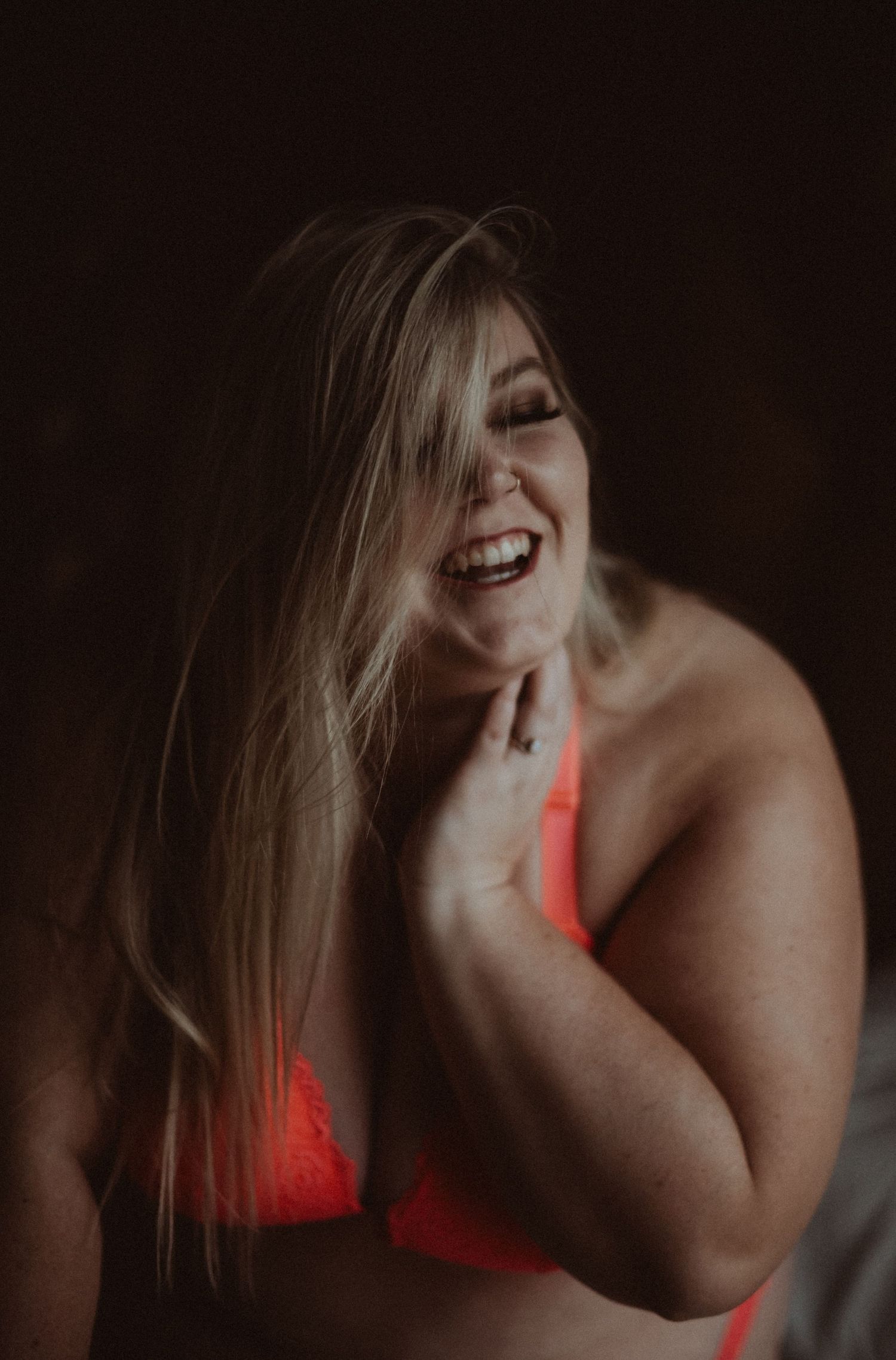 Artistic boudoir photo sequence featuring red lingerie in dramatic lighting and shadows.