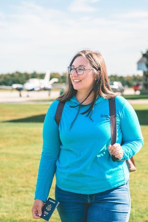 female travel agent walking away from airplane