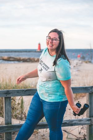 woman walks cheerfully down a boardwalk