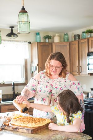Mother and daughter bake cupcakes in a kitchen