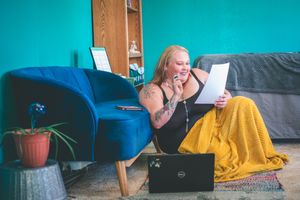 Podcaster recording a show for her personal brand in a cozy home studio.