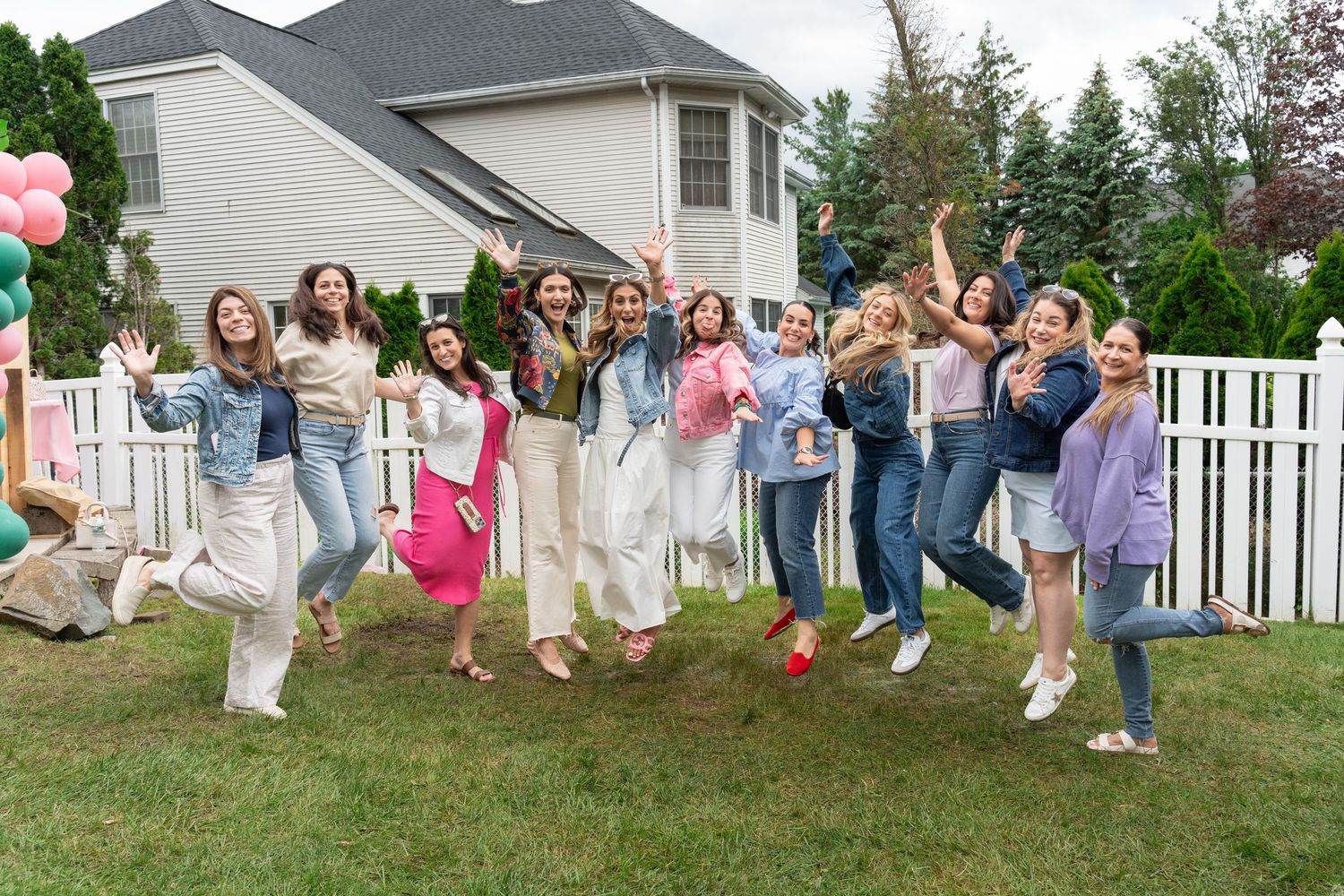 Group photo of party guests sitting on grass mid air (Friendship)