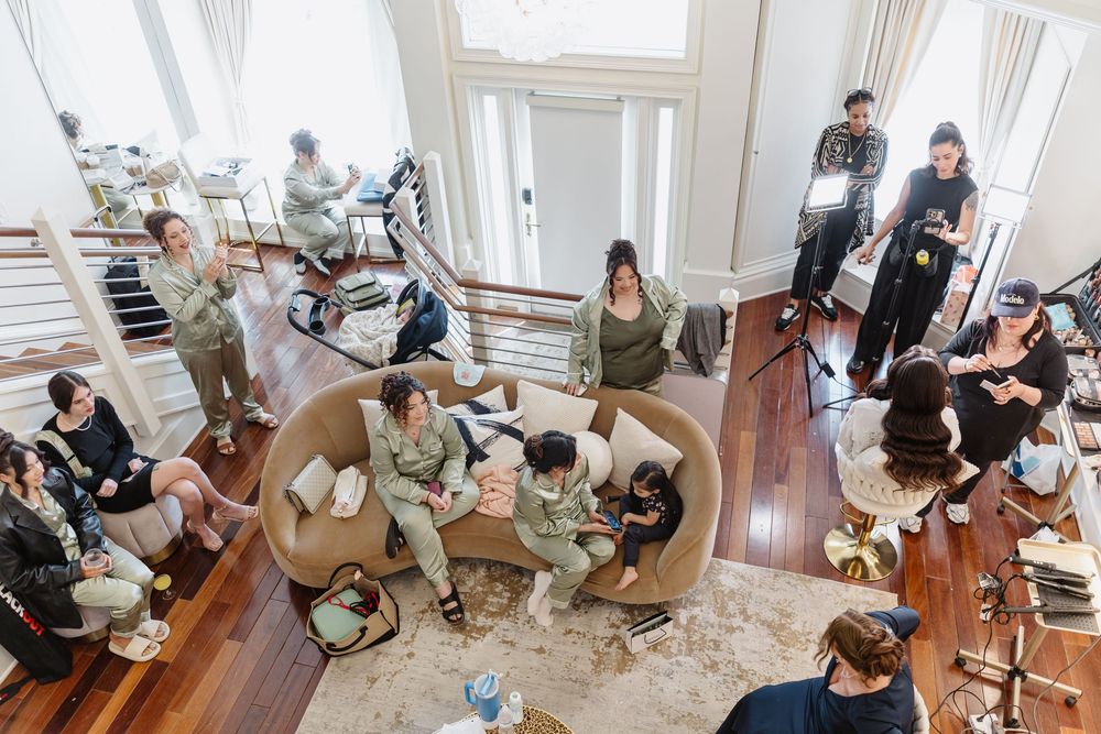 Aerial view of wedding preparations in a grand room with spiral staircase and hardwood floors.