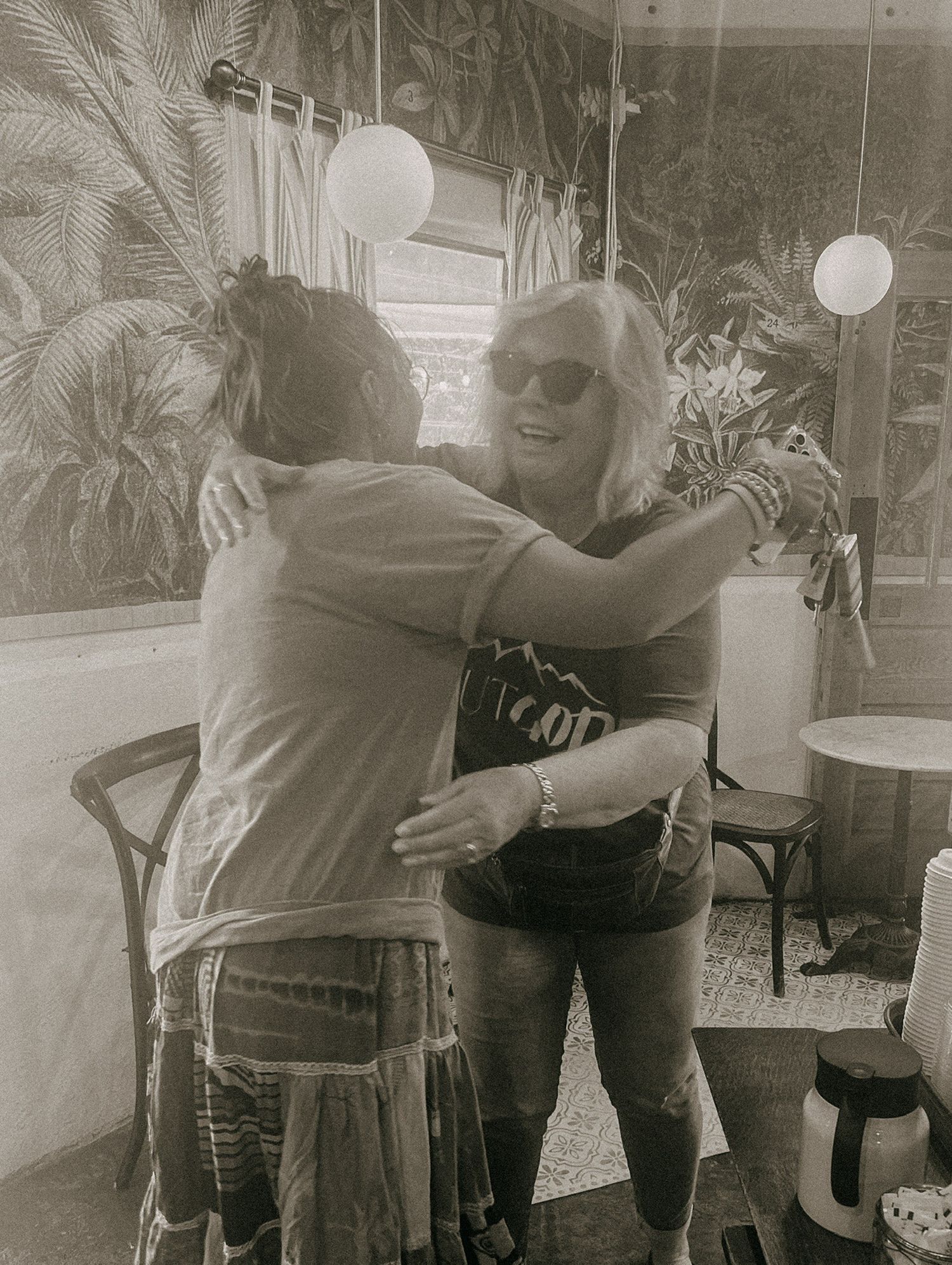 A heartwarming series of photos showing two people embracing in a restaurant setting with white lantern decorations.