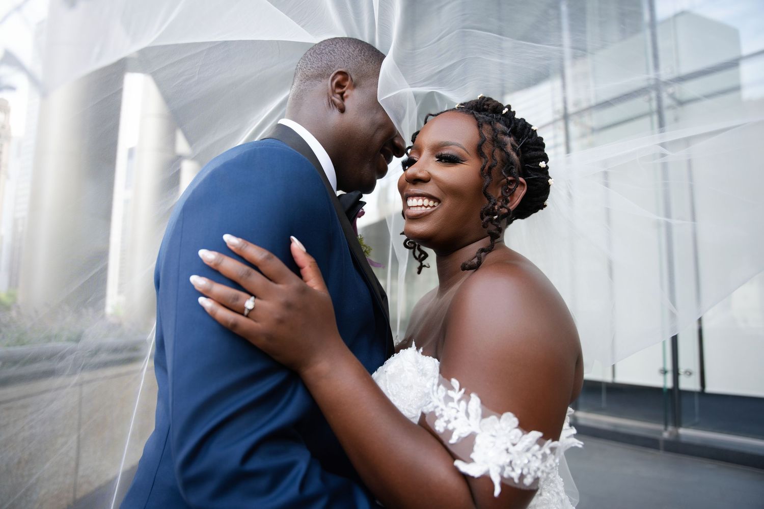 Chicago based wedding photographer and a couple share a romantic moment on their big day, with the bride in white and groom in navy blue.