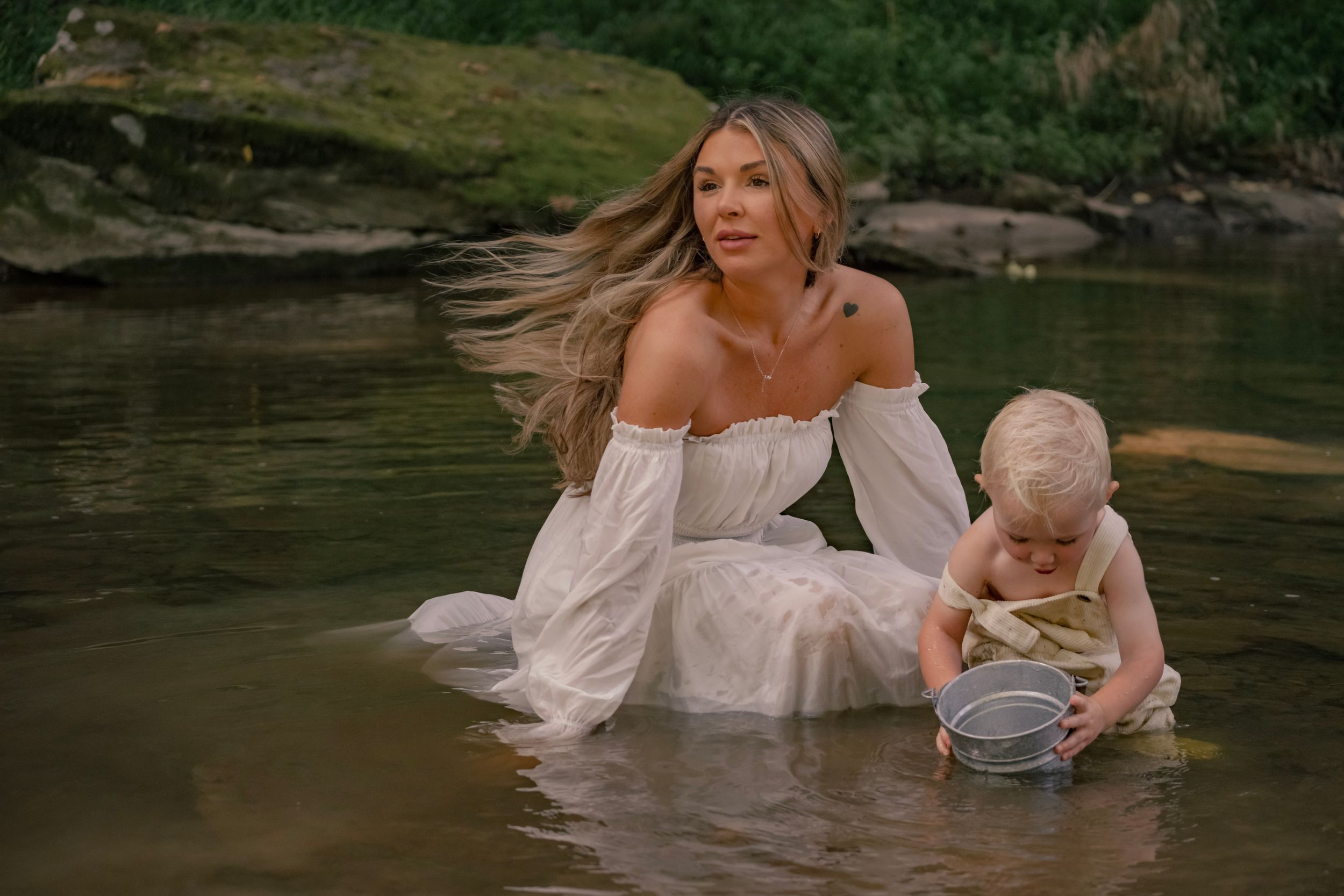 A dreamy portrait of a parent and child playing in shallow water during golden hour.

Pittsburgh, PA