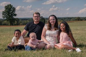 A series of candid outdoor family photos showing people laying in a grassy field on a sunny summer day.