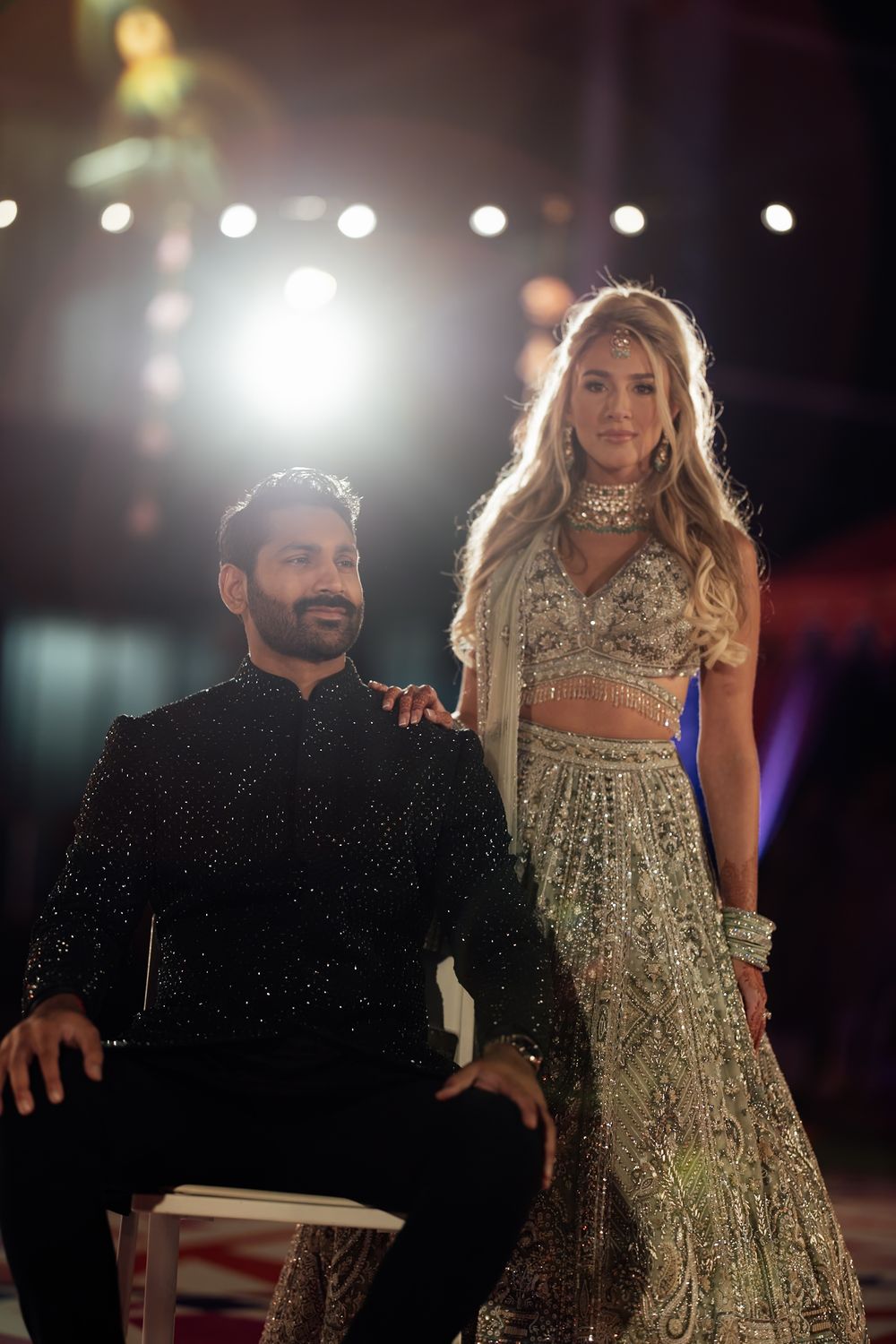 Glamorous evening celebration with sparkly outfits and dramatic stage lighting.