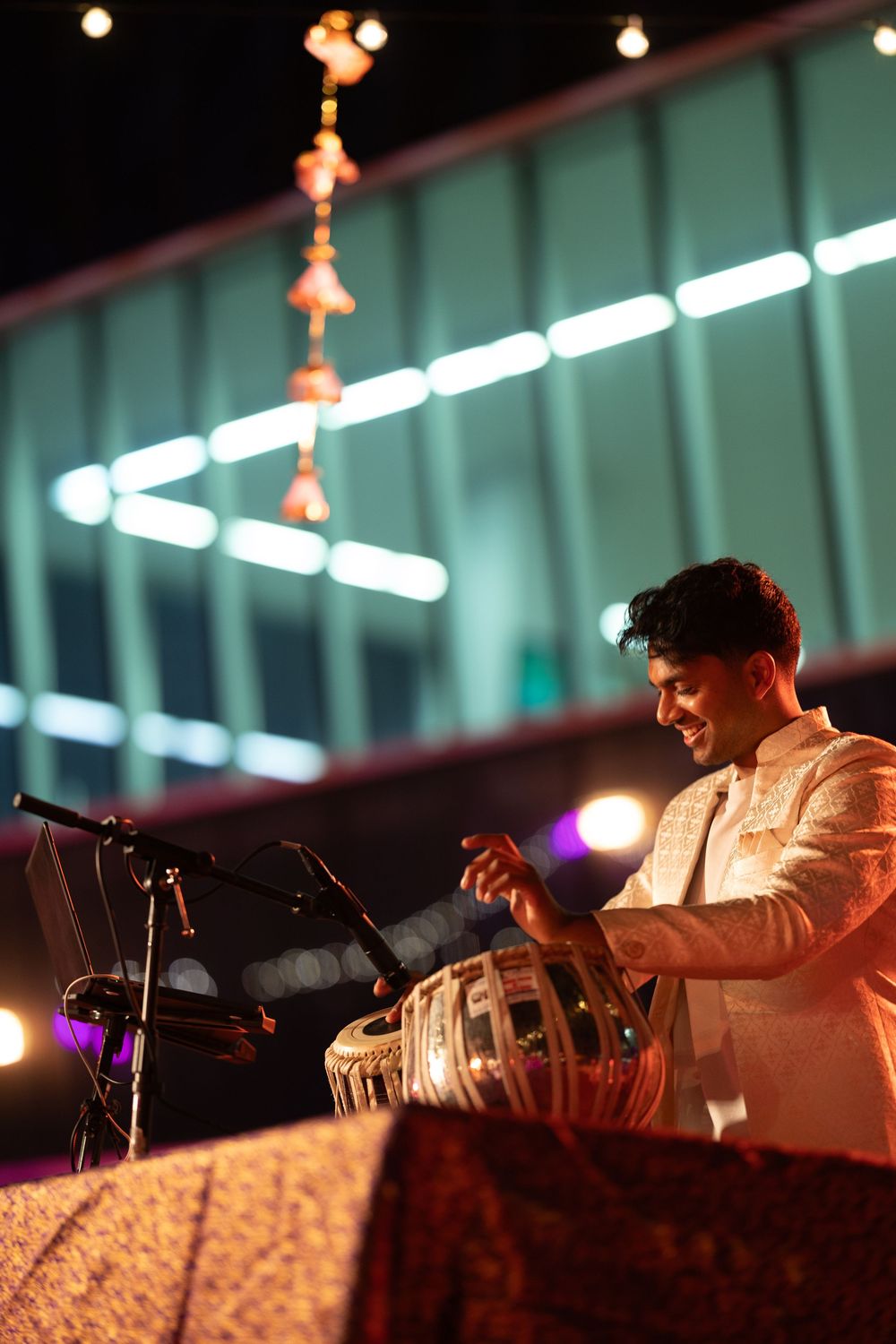 DJ performs at night wedding reception with colorful ambient lighting.