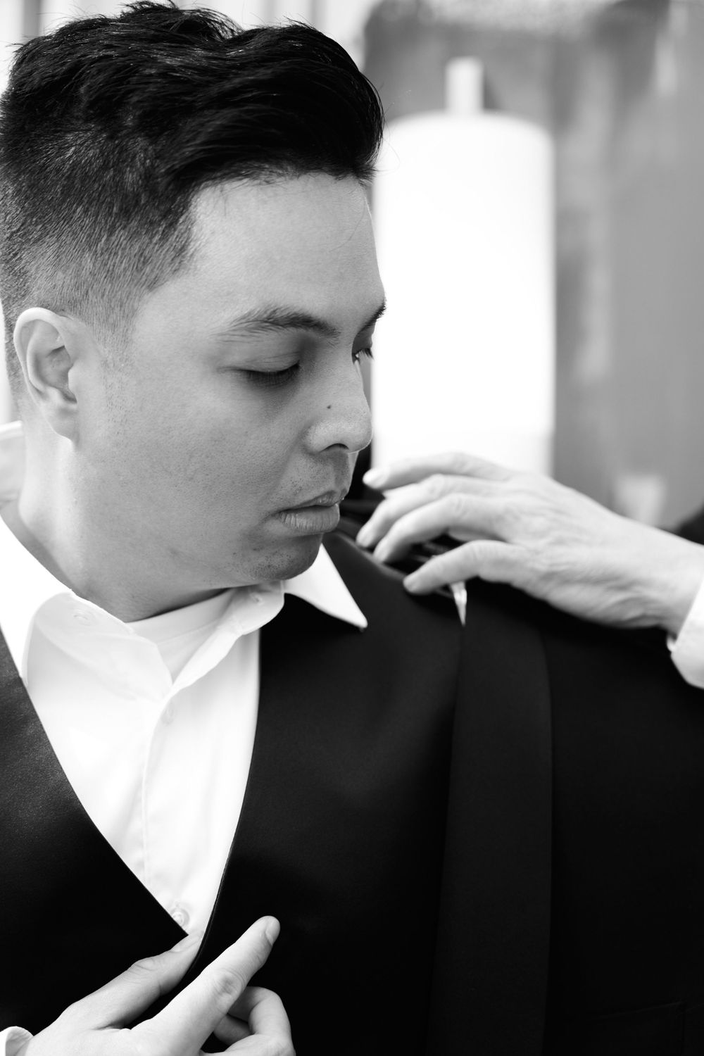 A black and white sequence showing someone blowing against a white collar in dramatic lighting. Hilton club the central 5th