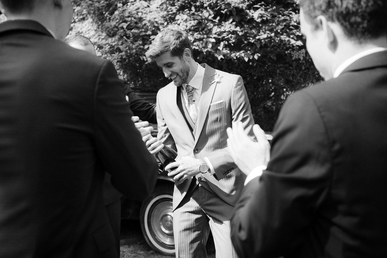 Black and white outdoor wedding moments captured between ceremony participants.