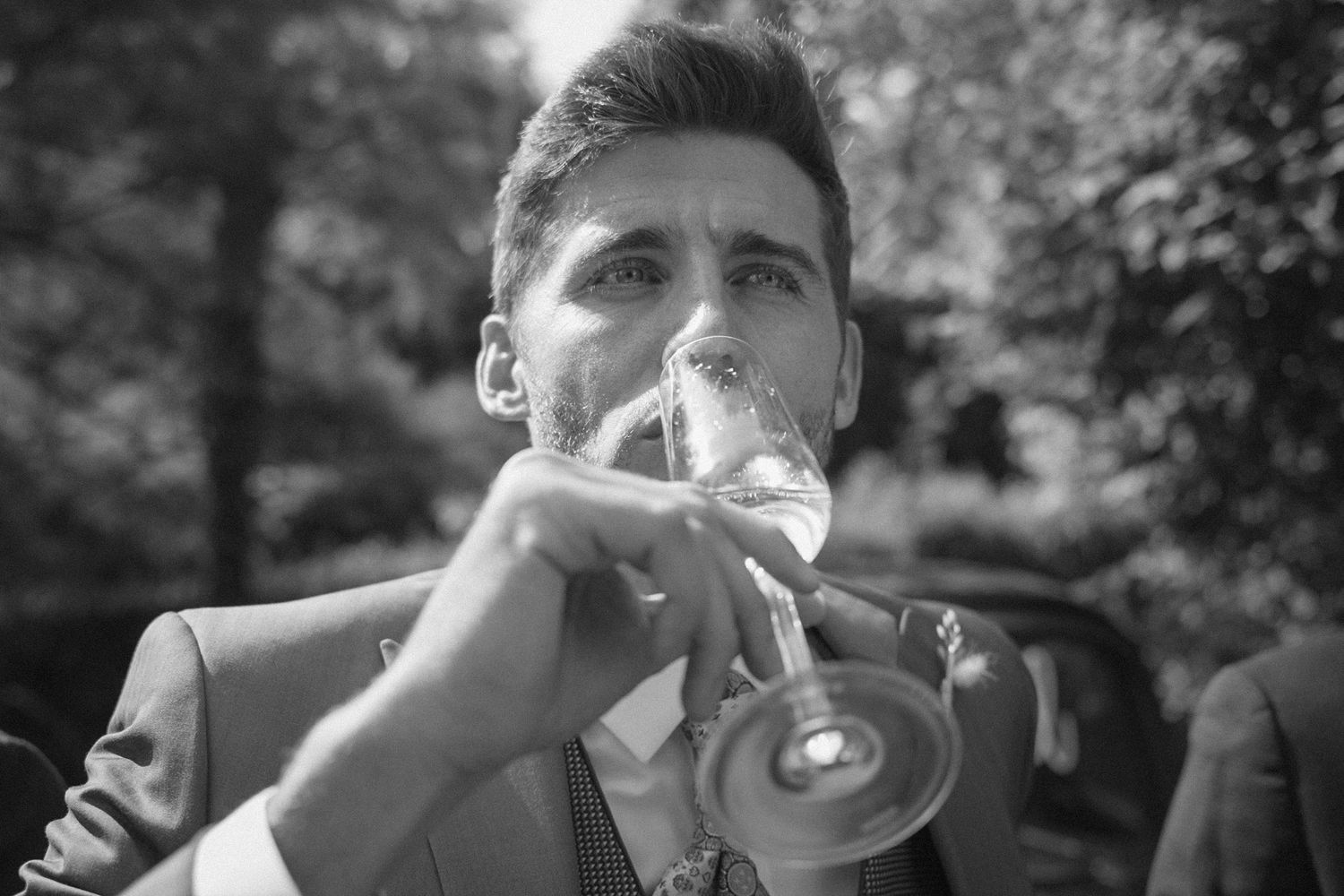 Black and white candid reactions of wedding guests during an outdoor celebration.