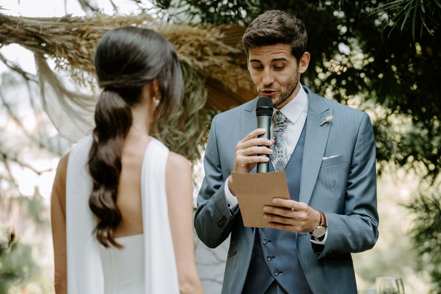 Couple sharing an intimate moment during their first look in a lush garden setting.