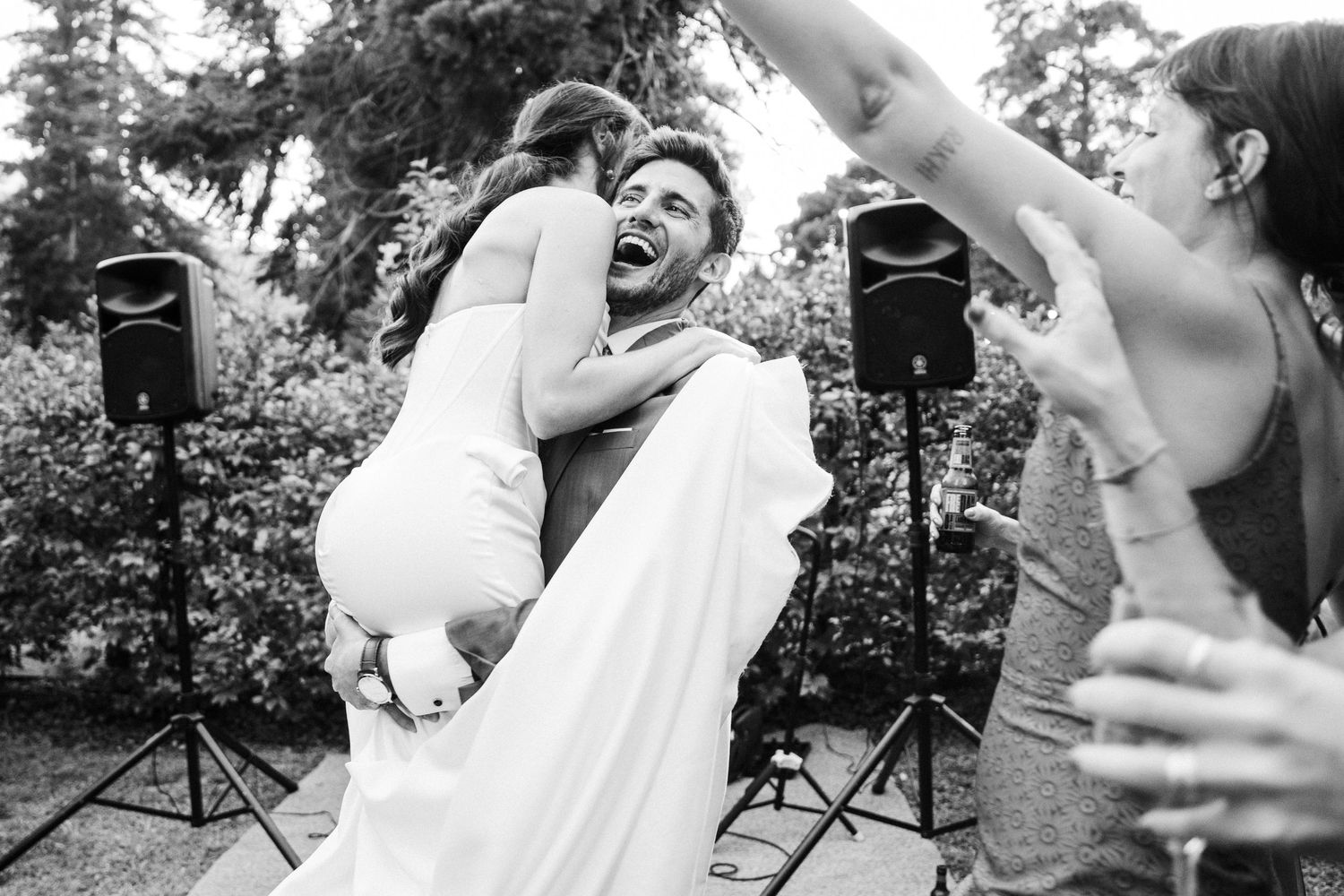 Dancing and celebration moments captured during an outdoor wedding reception.