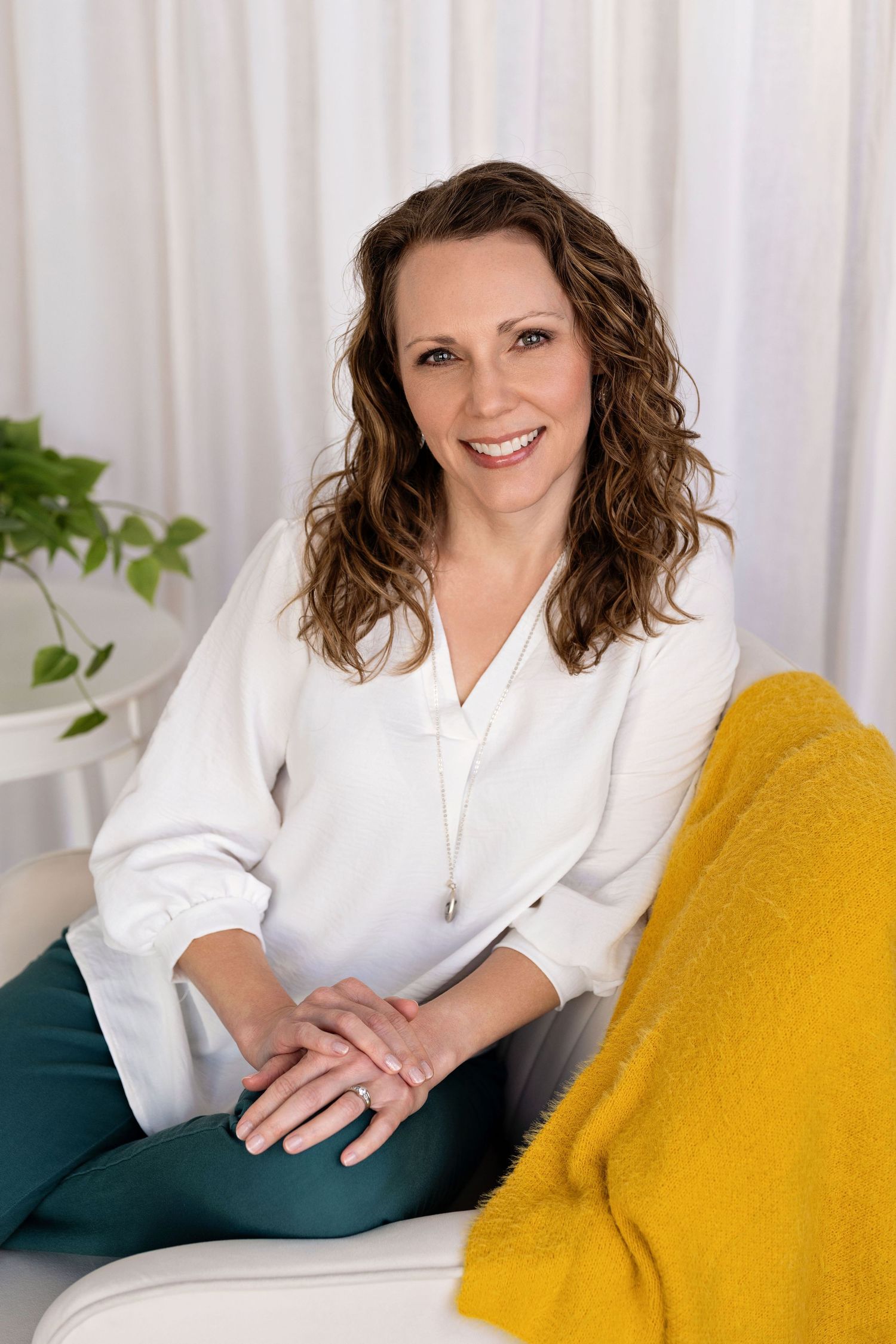 Professional headshots featuring warm smiles against white backdrop with yellow and teal accents.