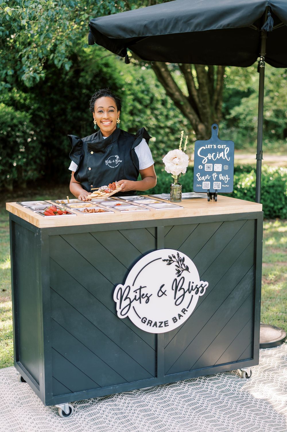 Black mobile bar setup with white signage for outdoor event service, used for branding photos in Fayetteville NC