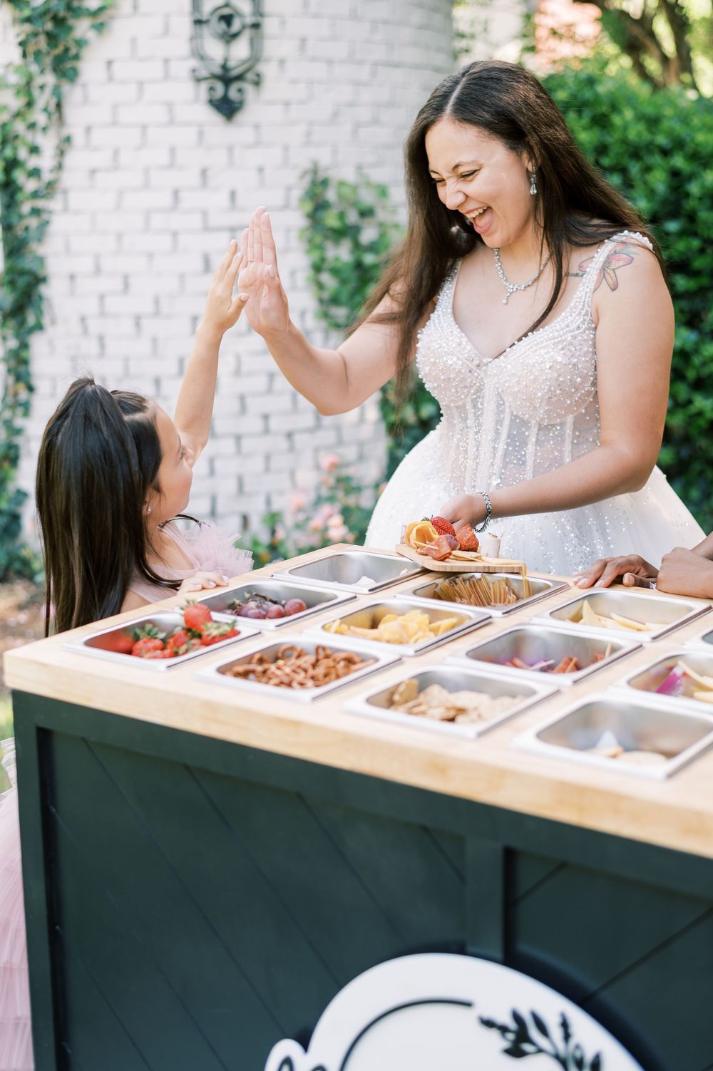 A close up of a grazing table with multiple food compartments labeled 'Bites & Blaze Bar' used for branding in Fayetteville NC