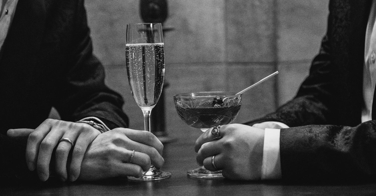 Black and white image of formal drinks and glassware on an elegant table setting.