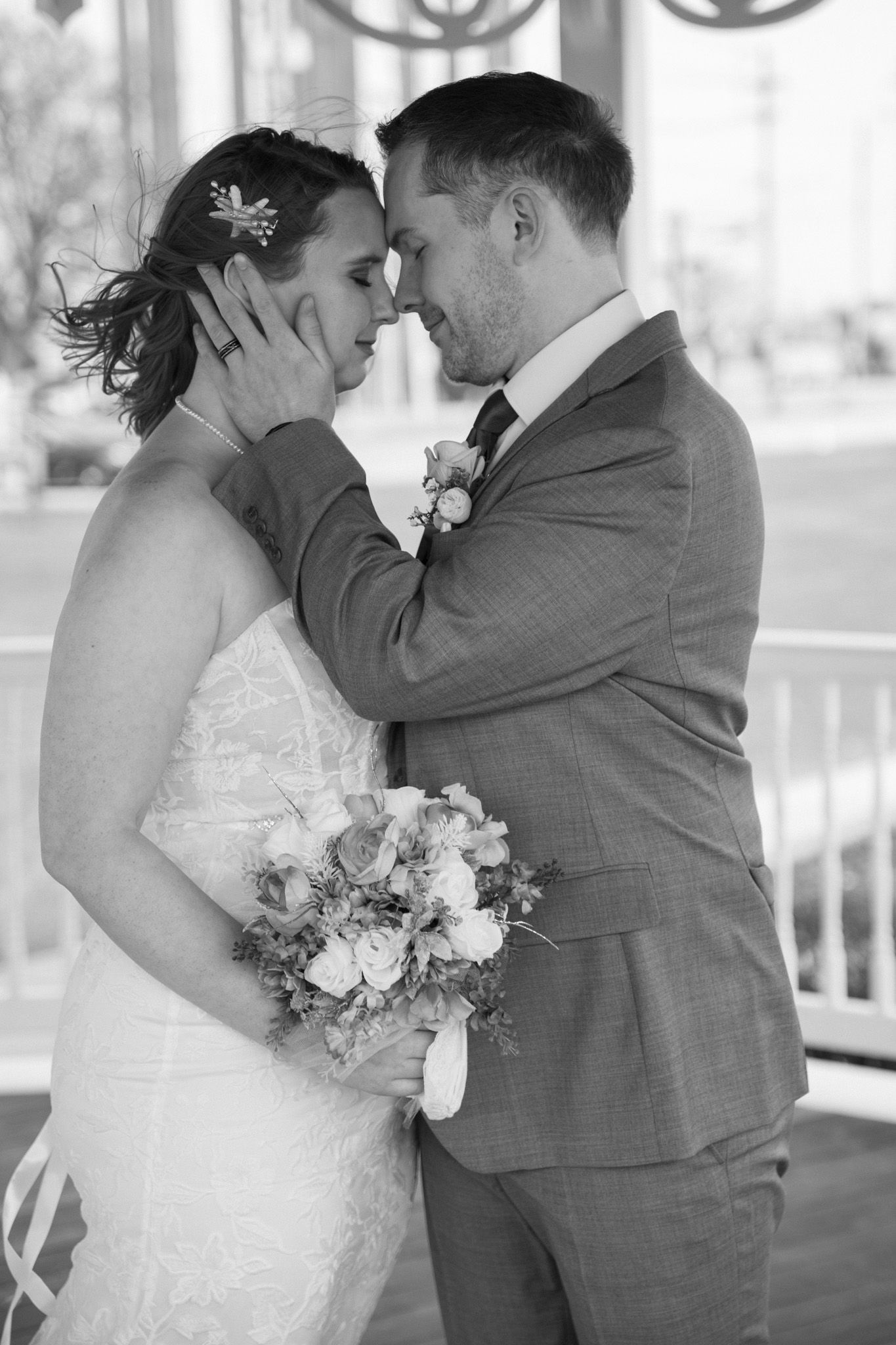 Black and white wedding photos showing intimate moments between newlyweds.