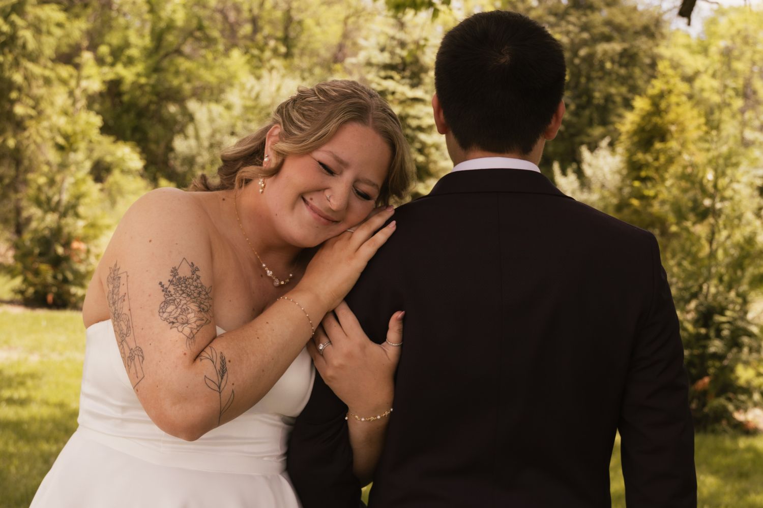 Romantic wedding couple sharing intimate moments in golden sunlight.