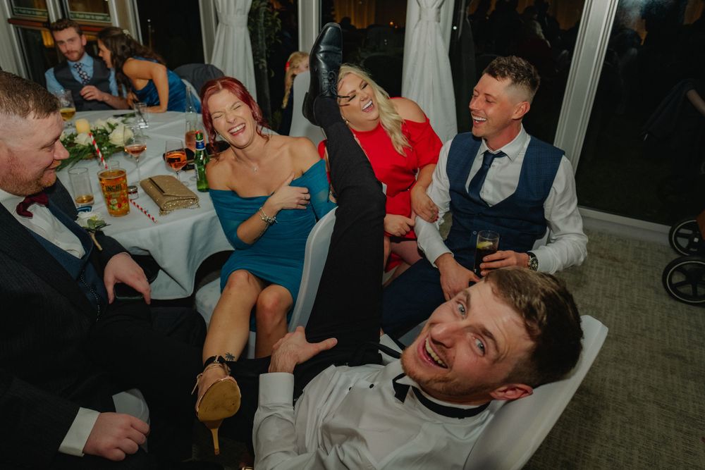 Candid shots of wedding guests laughing and socializing at reception tables.