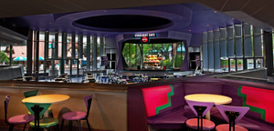Modern gaming arcade interior with dimly lit neon lighting and rows of arcade cabinets and gaming stations.