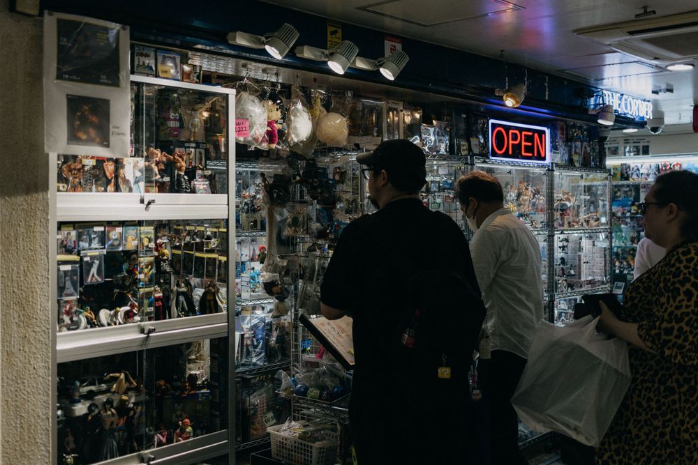 Dimly lit shop interior with display cases filled with collectibles.