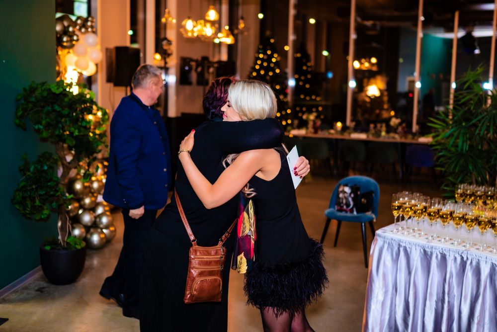 Guests dancing at a festive evening event with twinkling lights and holiday decorations.