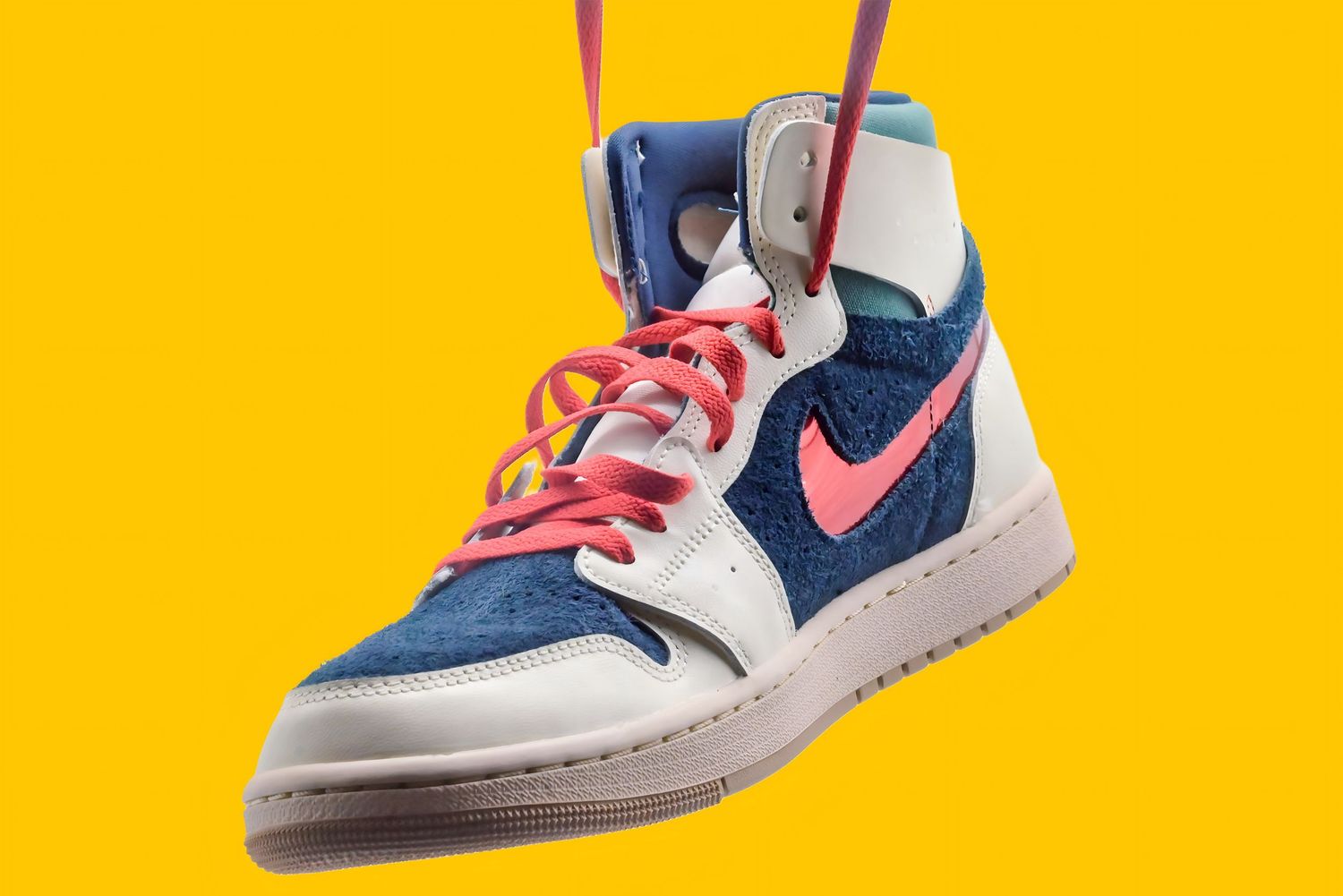 Vintage-style Nike sneakers in blue, white and red against bright yellow background.