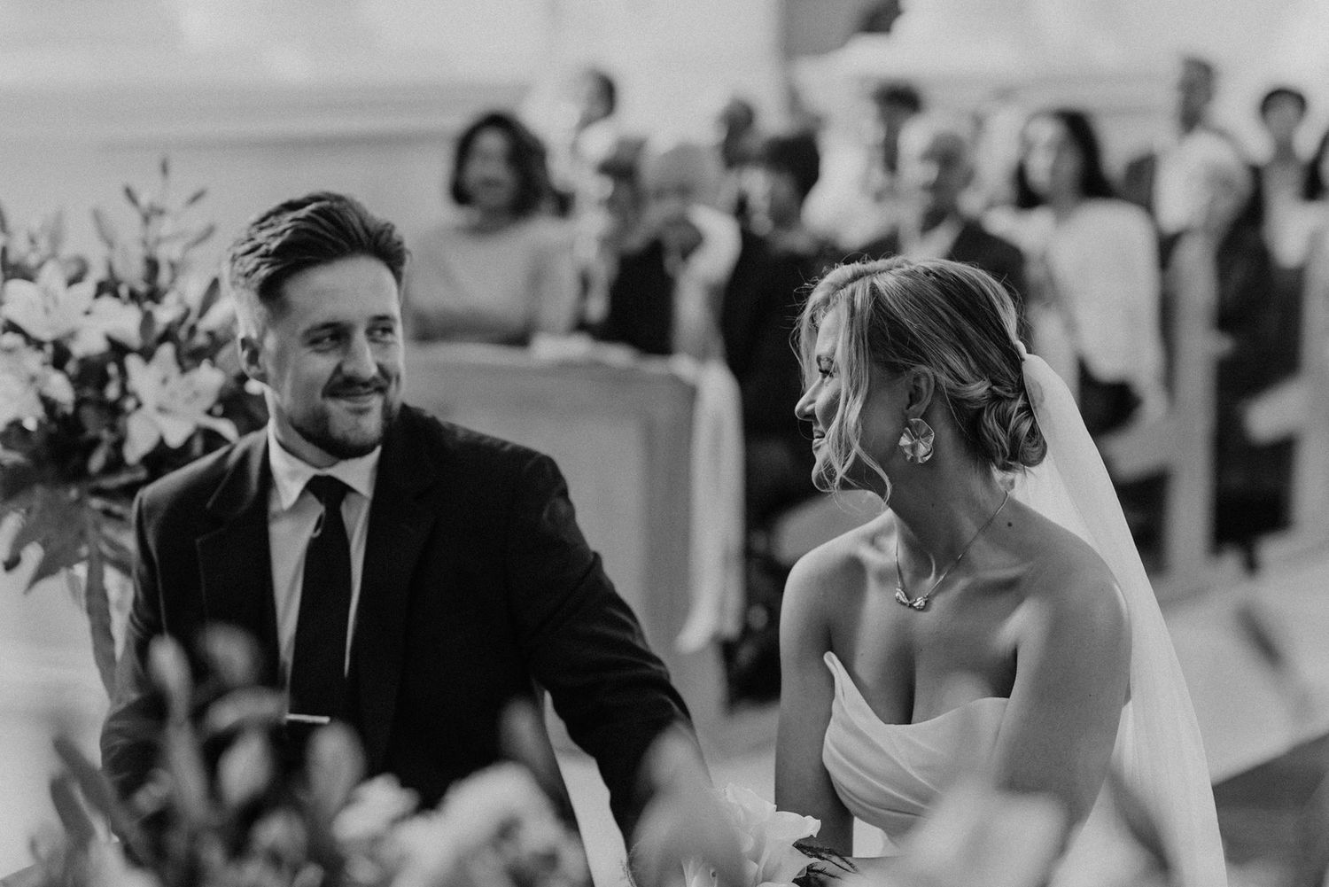 Black and white photo collage showing candid moments at a wedding reception with dancing and celebration.