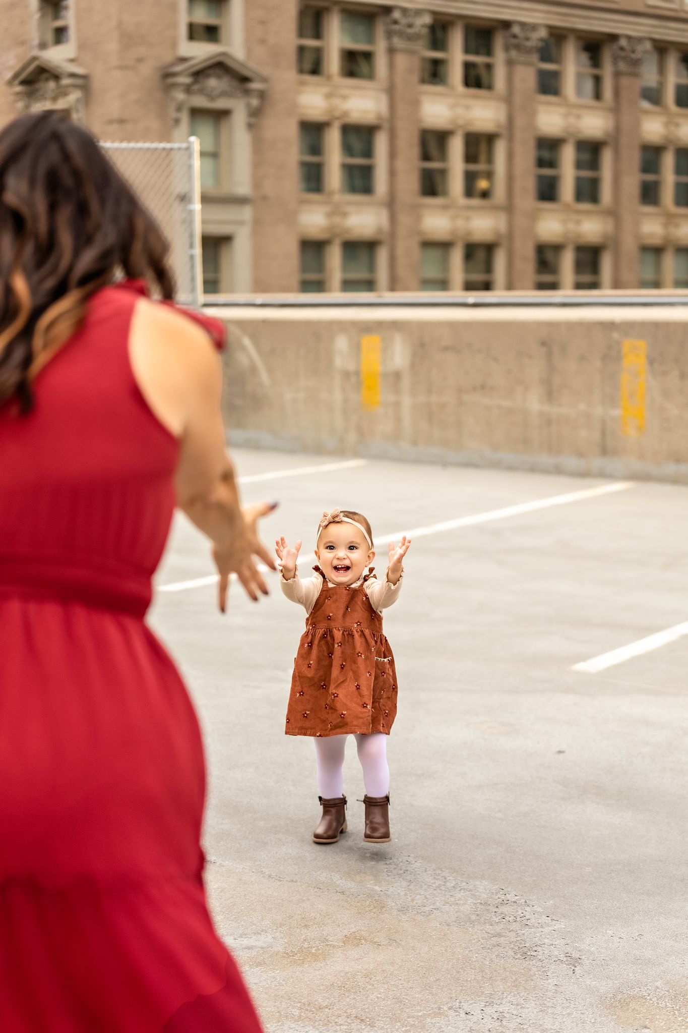 A series of progressive photos showing a young child learning to walk with adult assistance on a concrete walkway.