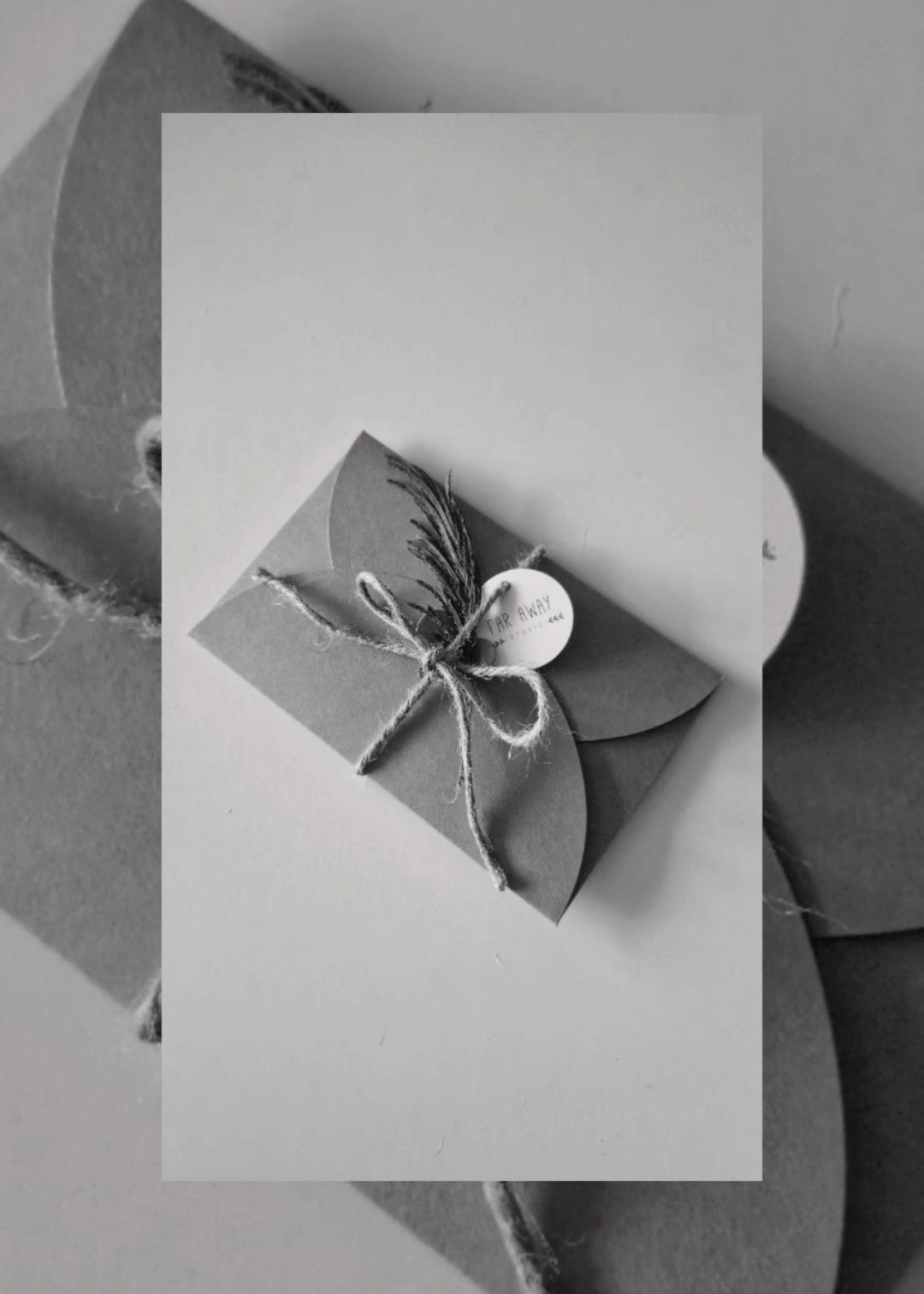 Elegant gray kraft paper gift box tied with twine and a wax seal on a neutral background.