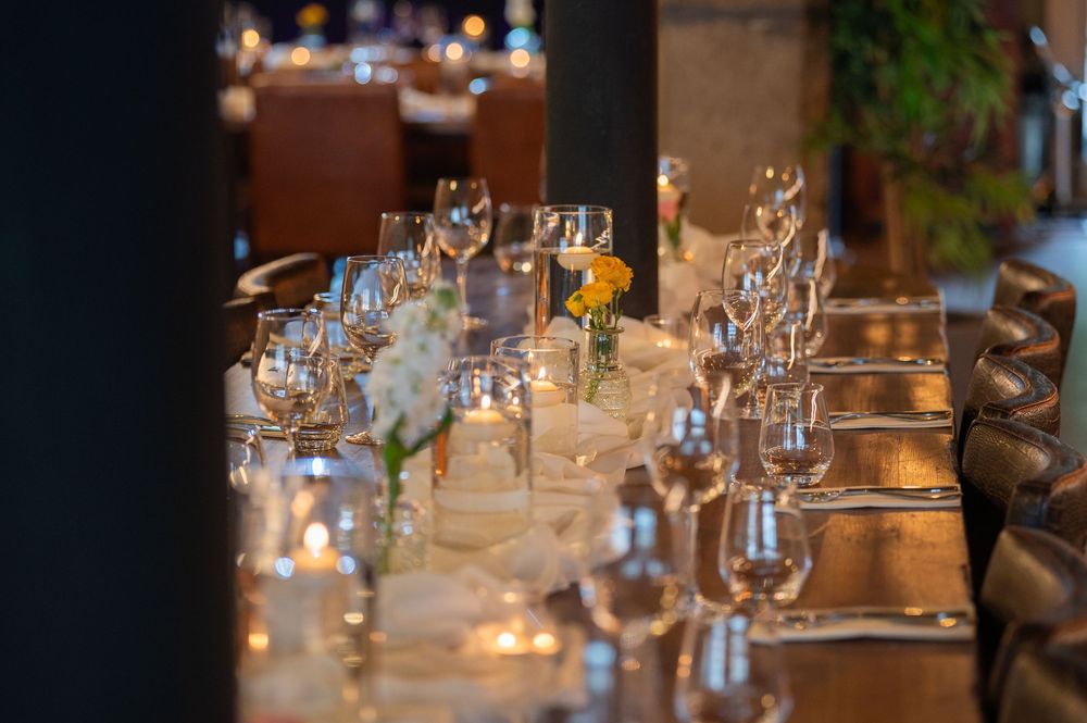 Elegant table setting with wine glasses and candlelight creating a romantic atmosphere.