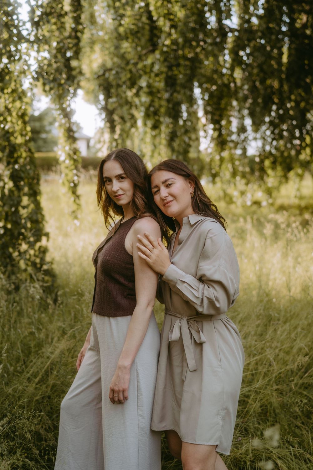 Candid moments of friendship captured in natural outdoor setting with neutral tones.