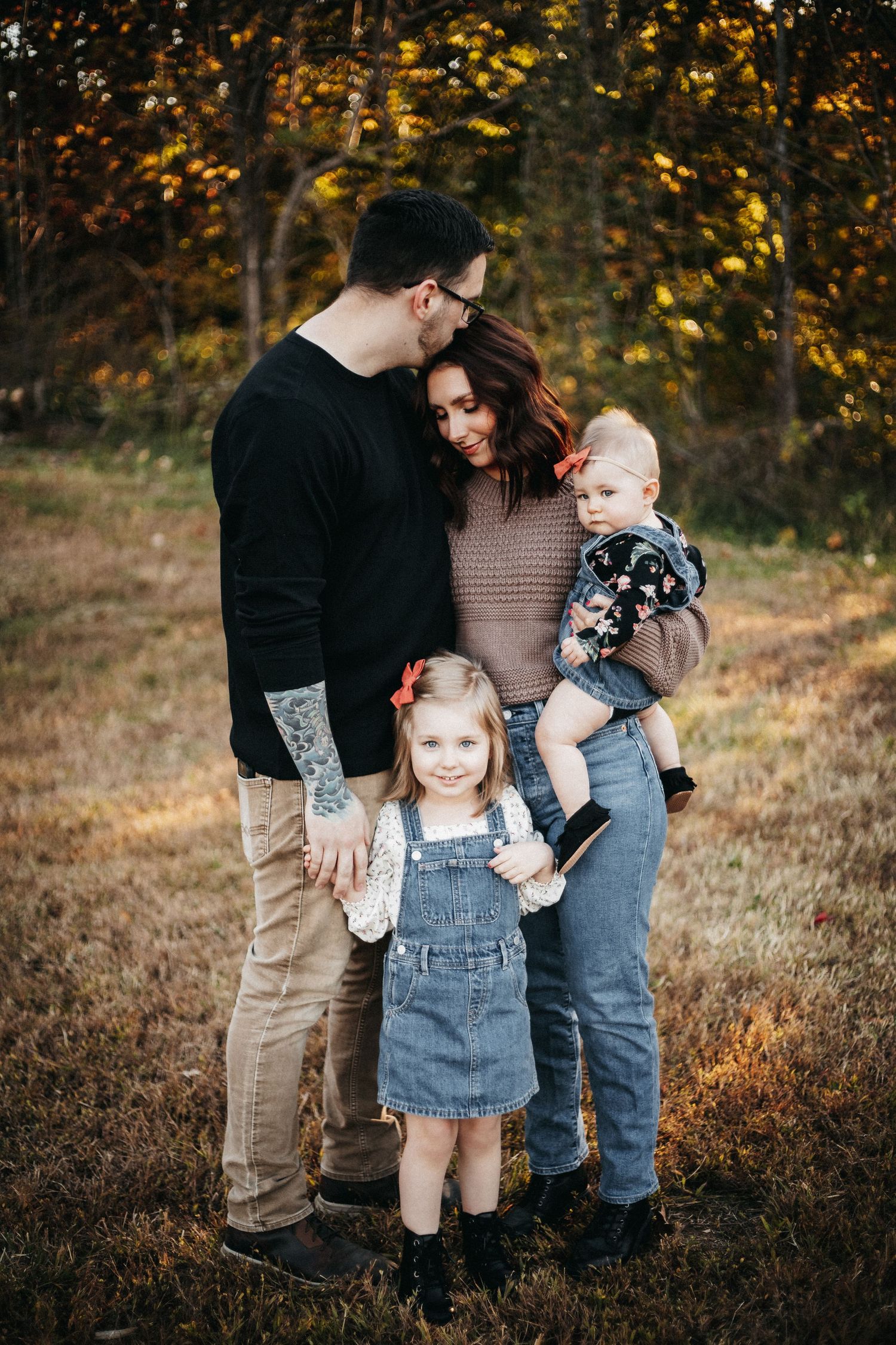 The Rhodes family embracing in a field located in Moneta, Virginia.