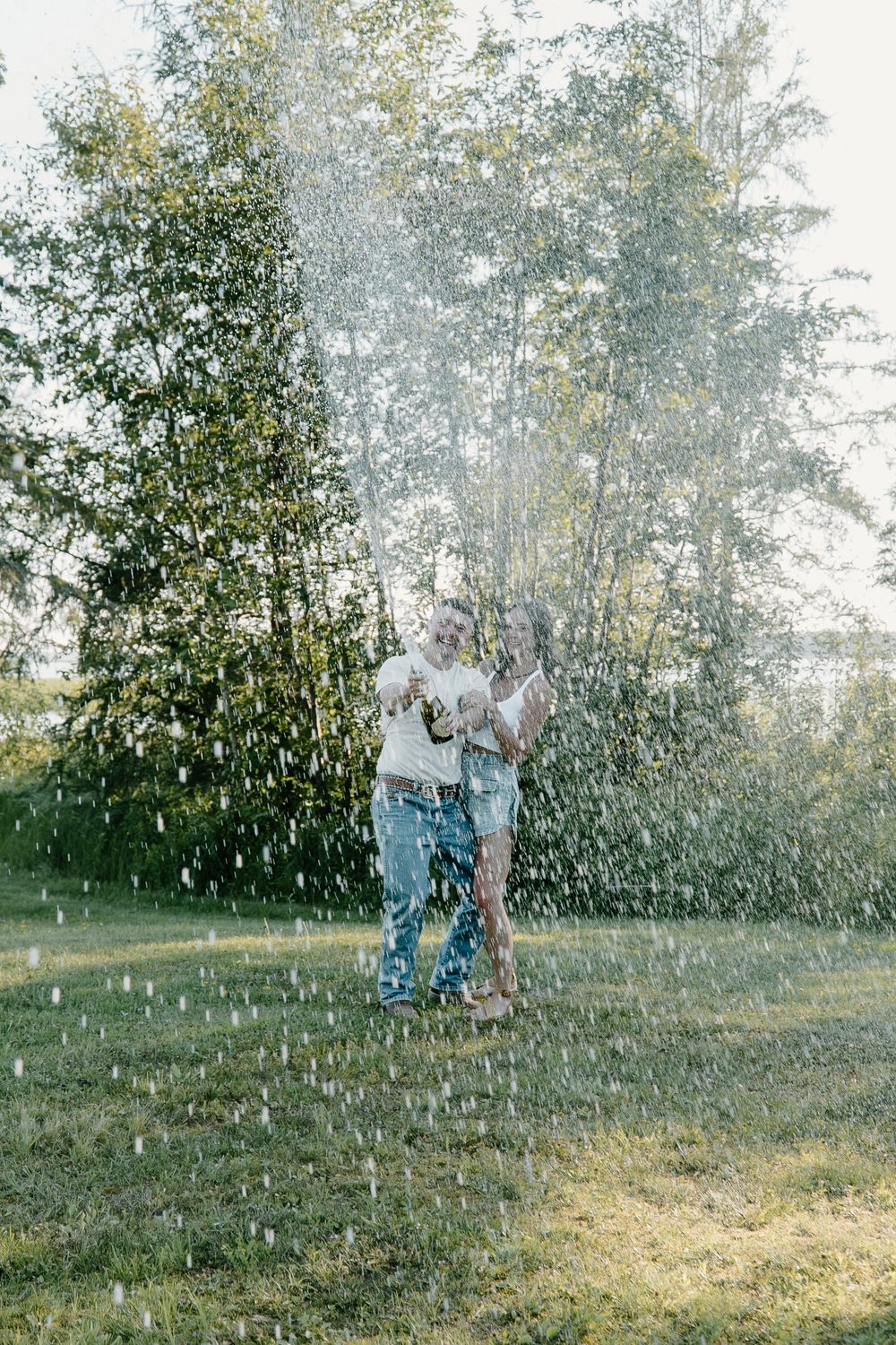 A sequence of photos showing two people playing and throwing white dandelion seeds in a sunlit meadow at golden hour.