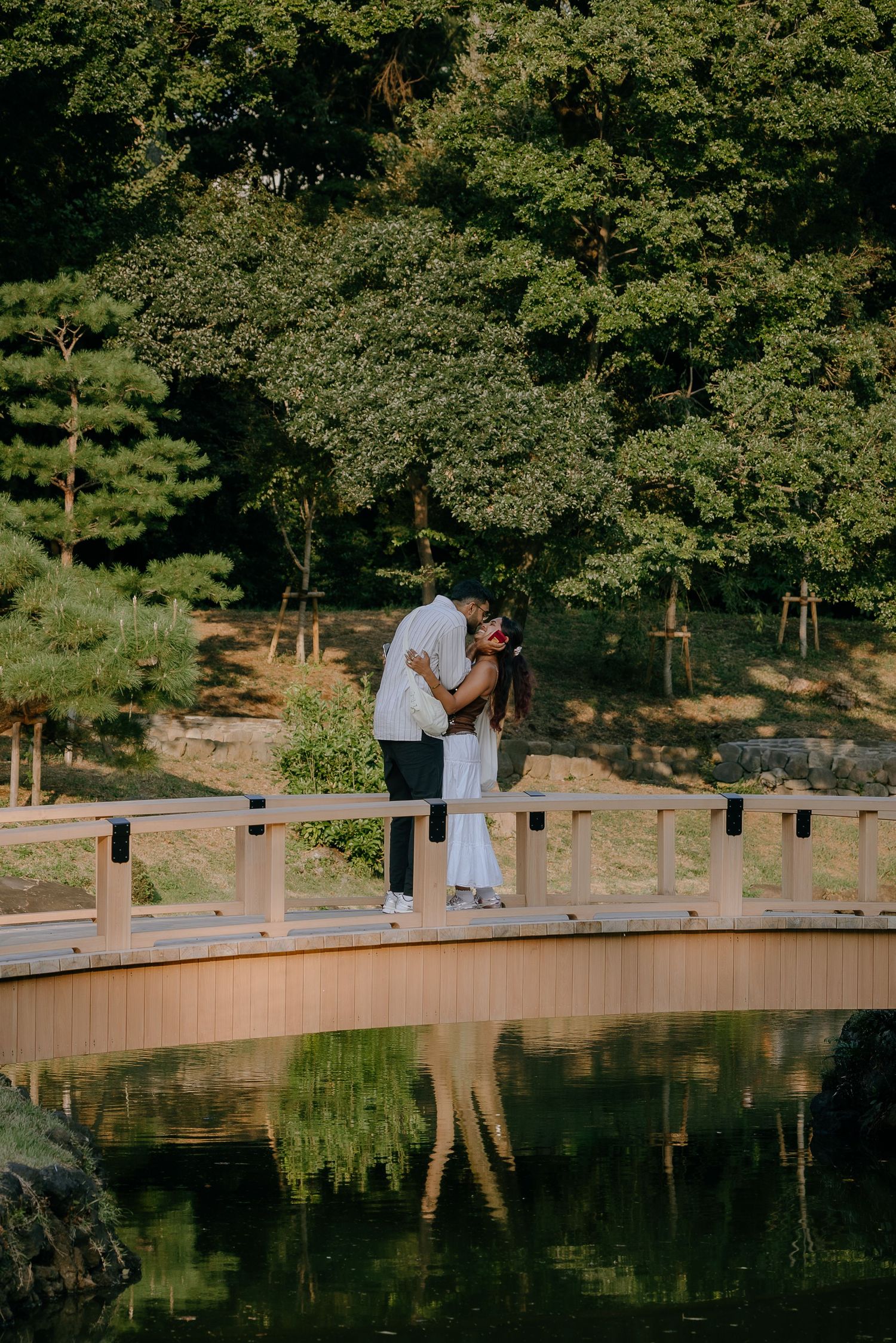 Surprise proposal at wooden bridge of Japanese garden at Shinjuku Gyoen National Garden