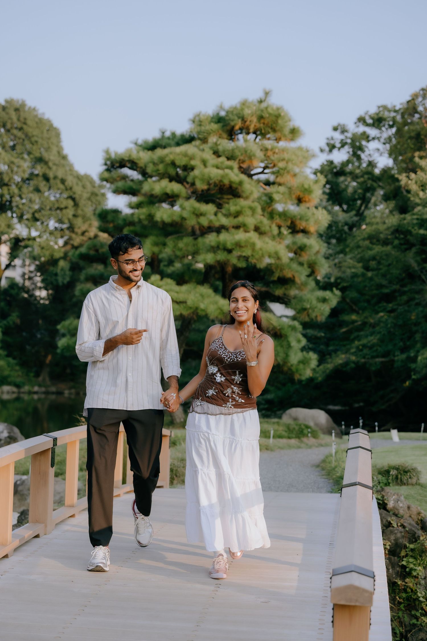 Surprise proposal at wooden bridge of Japanese garden at Shinjuku Gyoen National Garden