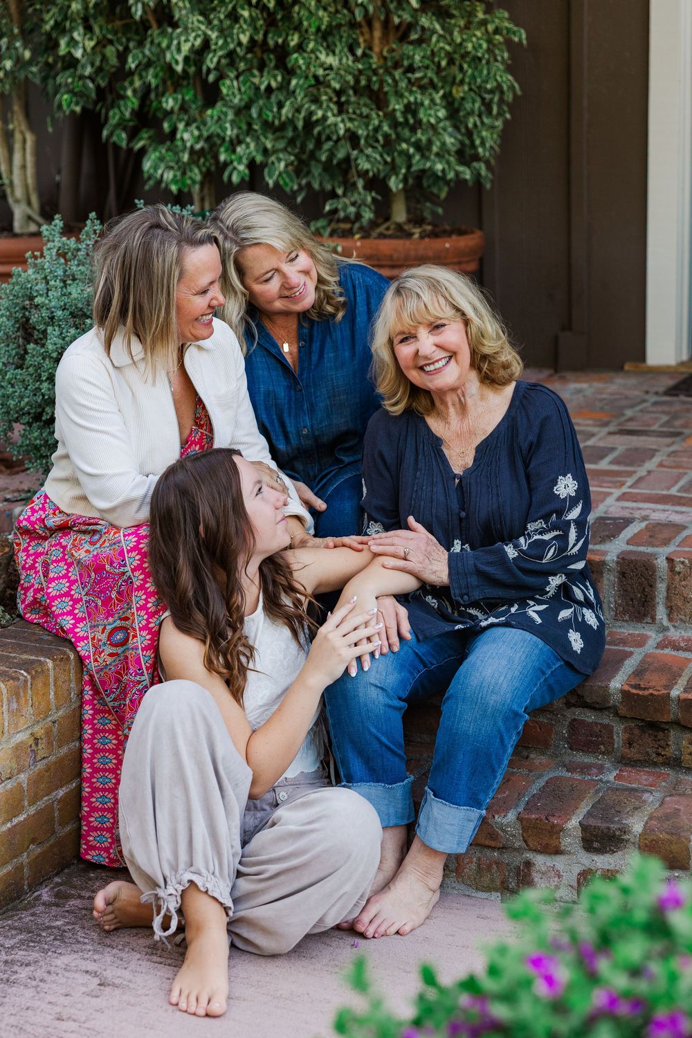 A candid series of photos showing joyful moments shared on brick steps with flowers in the foreground.