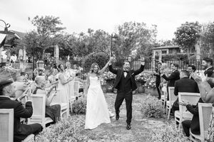 Garden wedding celebration with guests mingling outdoors.